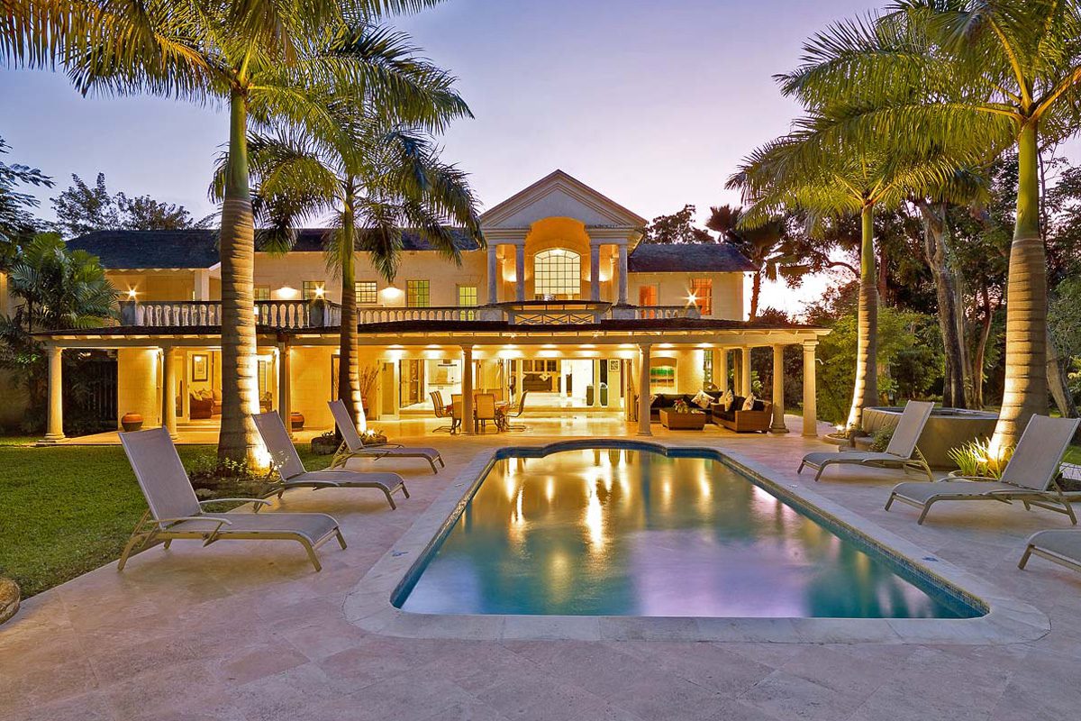 Amberley house pool with villa behind lit up