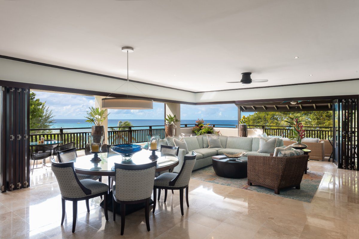 Lounging and dining area of Crows Nest, a beachfront luxury condo in Paynes Bay Barbados