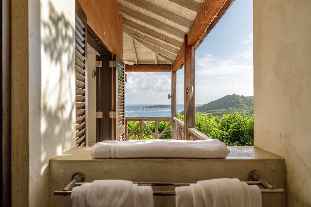 Picturing the views from one of our luxury villas on Macroni Beach on Mustique Island, of the surrounding beach and picturesque forest.