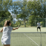 Two guests play tennis in winter in the Caribbean during their stay at one of our luxury Caribbean vllas.