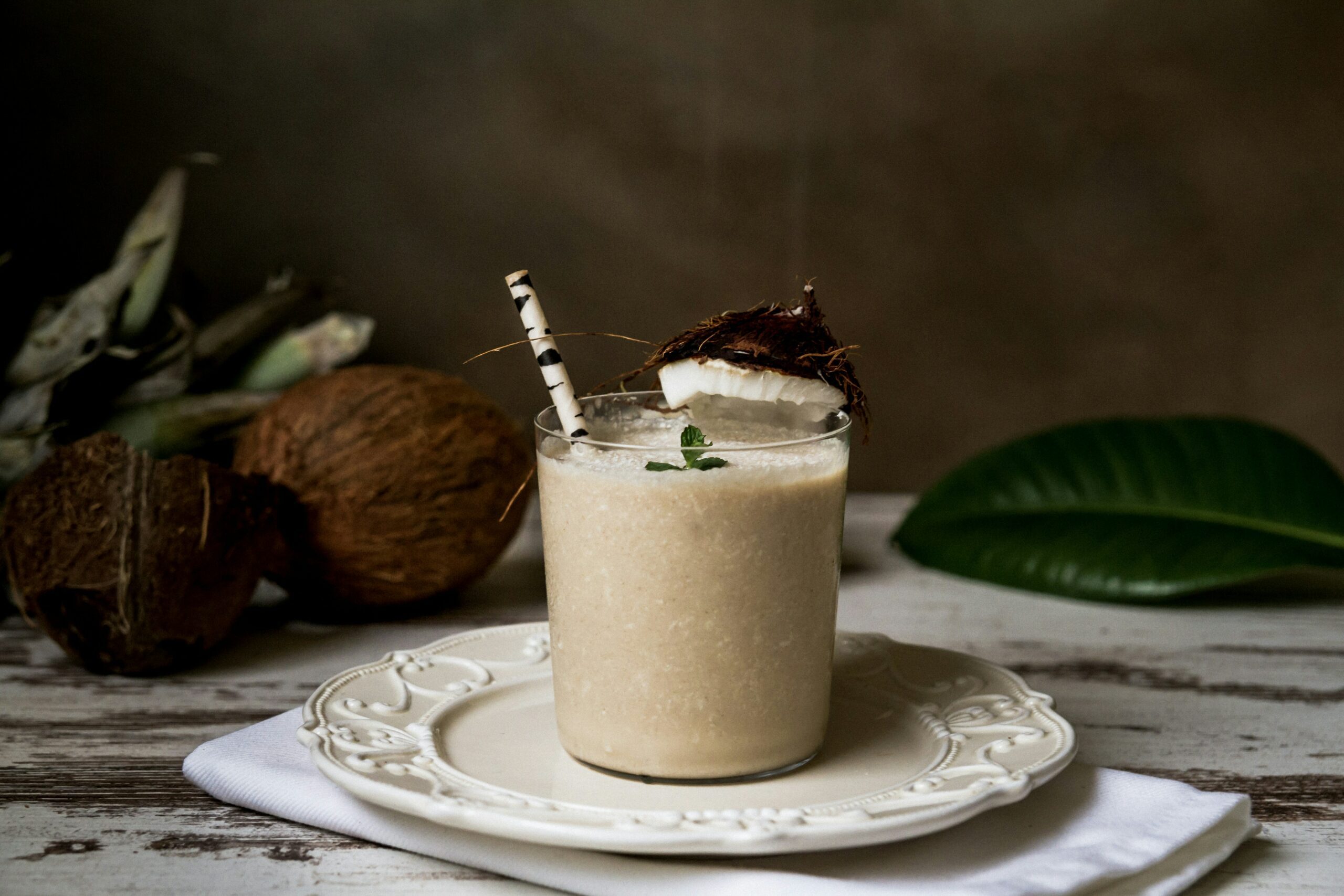 Another delicious drink in the Caribbean, this coconut mojito will keep anyone hydrated with its surplus of electrolytes, served in a glass with a straw and garnished with a little bit of coconut husk.