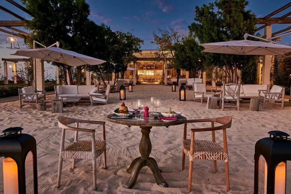 One of the best restaurants on Canouan Island in the Caribbean country of St. Vincent and the Grenadines, Shenanigans is right on the beach, as pictured and chairs and tables are set up directly on the sand.