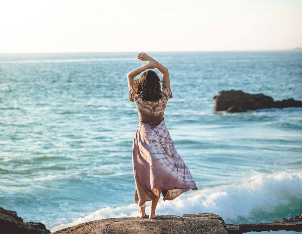 A woman standing in front of one of the top 5 beaches in Greece