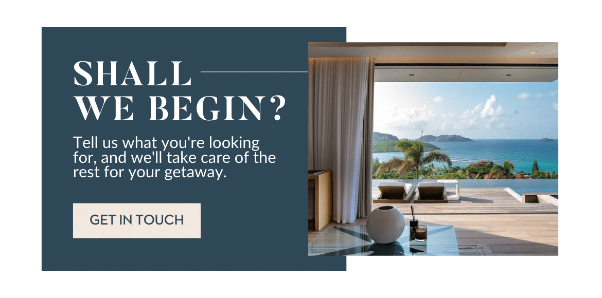 A modern room with an open sliding door showing a patio and ocean view; text on a blue background reads: Shall we begin? Tell us what youre looking for, and well take care of the rest for your getaway. Get in touch.